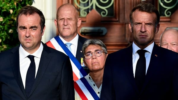 Sebastien Lecornu and France's President Emmanuel Macron stand during a ceremony marking the 81st anniversary of the liberation of Bormes-les-Mimosas during World War II
