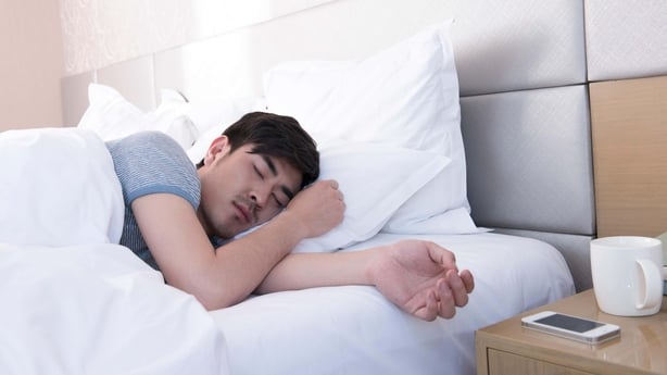 a man sleeping in a bed