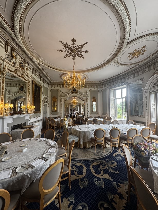 An ornate reception room with a chandelier 