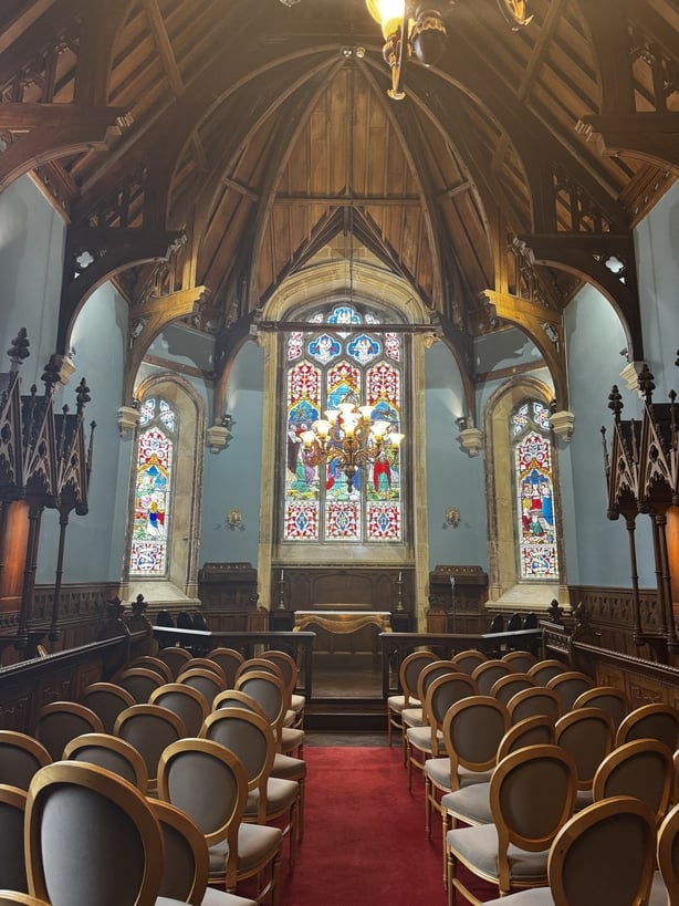 An ornate room with chairs and high ceilings