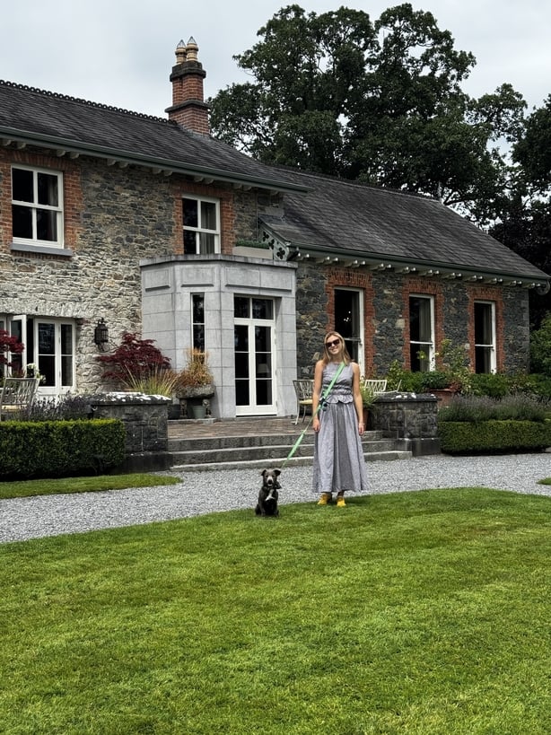 A woman and her dog standing in front of Virginia Park Lodge