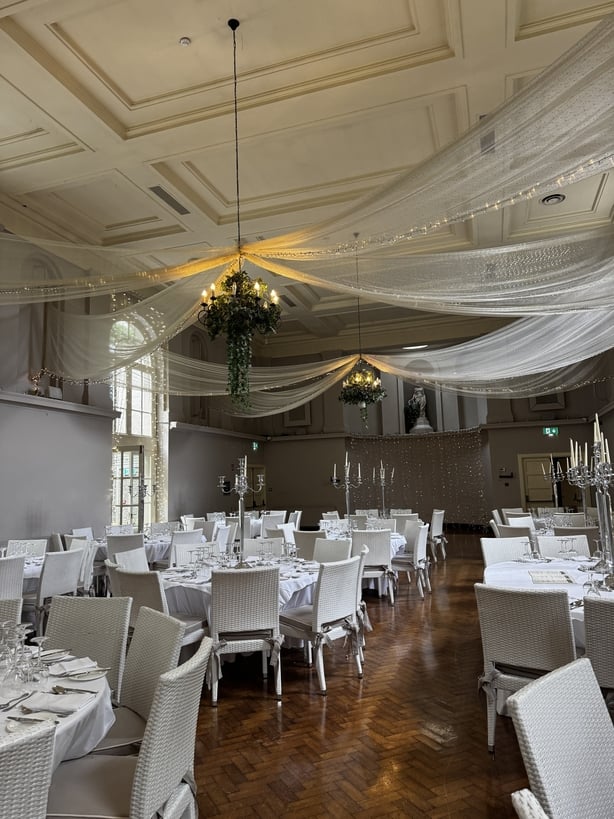 A reception room with fabric bunting on the ceiling