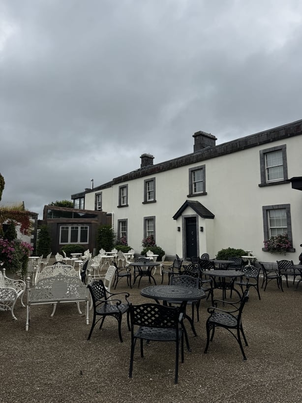The exterior of Clonabreany with tables and chairs