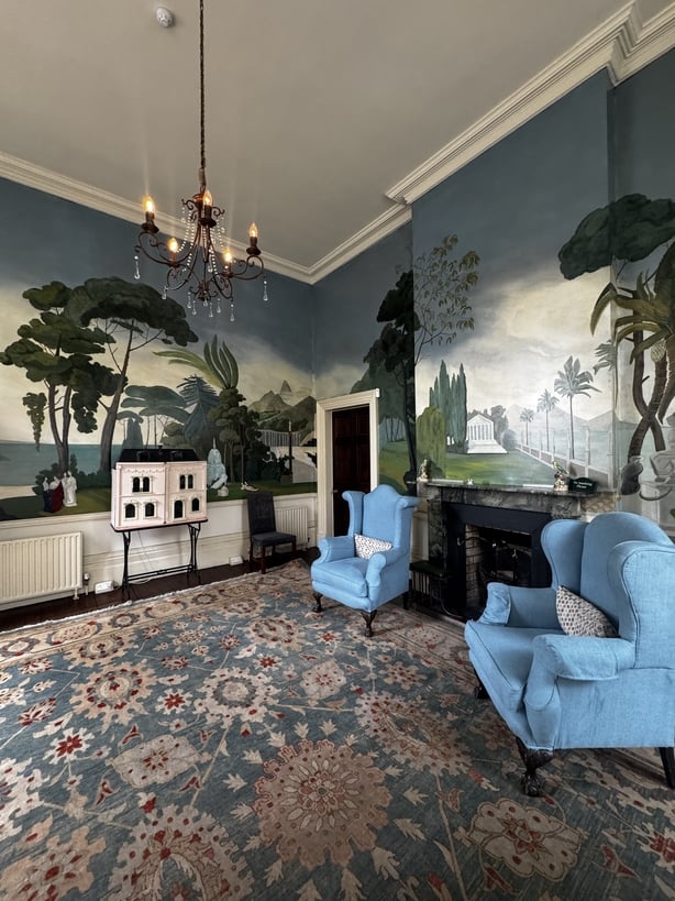 an ornate room with painted walls