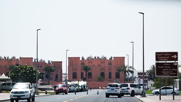 A picture taken from a distance shows the damaged building (L) in the compound housing members of Palestinian militant group Hamas's