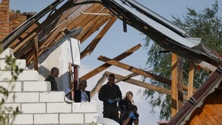 Police and army inspect damage to a house destroyed by debris from a shot down Russian drone in the village of Wyryki-Wola, eastern Poland