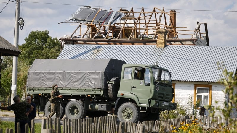 Police and army inspect damage to a house destroyed by debris from a shot-down Russian drone in the village of Wyryki-Wola, eastern Poland
