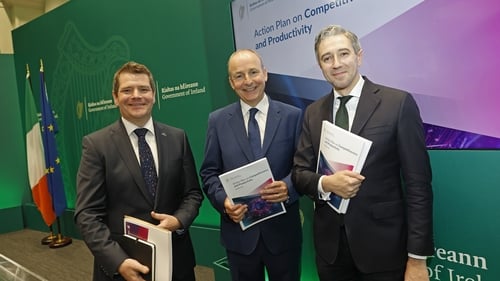 Taoiseach Micheál Martin (centre) Tánaiste Simon Harris (right) and Minister for Enterprise, Tourism and Employment Peter Burke (left) at today's launch