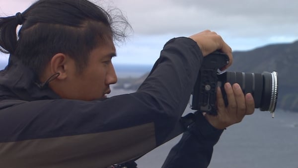 A content creator takes a photo at Sliabh Liag in Co Donegal