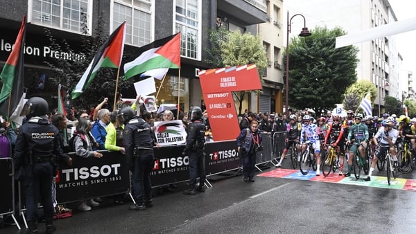 Pro-Palestinians protesters wave Palestinian flags as riders wait to take the start of the 17th stage of the Vuelta a Espana, a 143 km race between O Barco de Valdeorras and Alto de El Morredero, Ponferrada Pro-Palestinians protesters wave Palestinian flags as riders wait to take the start of the 17th stage of the Vuelta a Espana, a 143 km race between O Barco de Valdeorras and Alto de El Morredero, Ponferrada