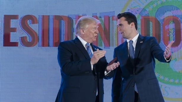 Charlie Kirk, president and founder of Turning Point USA, right, greets U.S. President Donald Trump during the Turning Point USA Student Action Summit in Washington, D.C., U.S., on Tuesday, July 23, 2019. Trump is predicting that his attack on Minnesota congresswoman Ilhan Omar -- now in its second