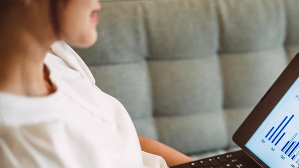 Woman reading data on a laptop