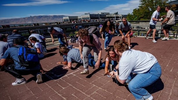 People run after shots were fired during an appearance by Charlie Kirk at Utah Valley University