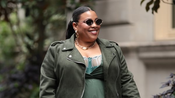 NEW YORK, NEW YORK - SEPTEMBER 10: Greivy seen wearing Diff gold cat-eye sunglasses with dark lenses, J. Crew gold hoop earrings and gold chain necklace, Lost Patterns green polka-dot scarf tied around her ponytail, Julie Vos gold rings, Derek lam flowy v