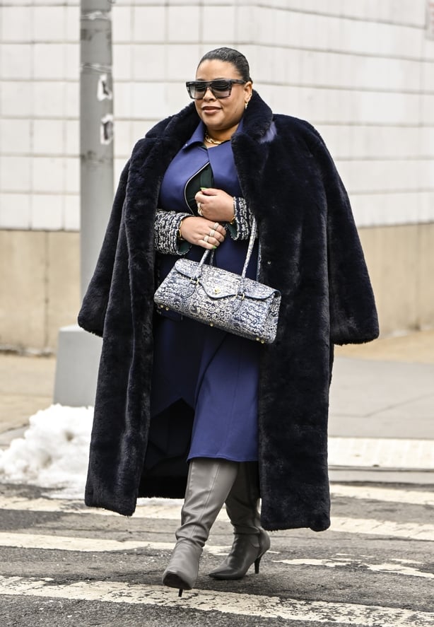 NEW YORK, NEW YORK - FEBRUARY 11: Greivy Lou is seen wearing a L'Agence coat, Ming Want blazer and skirt, Wray mesh top, Franco Sarto boots, Victoria Beckham sunglasses, J. Crew jewelry and France Luxe hair clips outside the Michael Kors show during NYFW F/W 2025 on February 11, 2025 in New York Cit