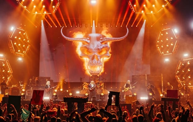 landscape shot of Spinal Tap on stage