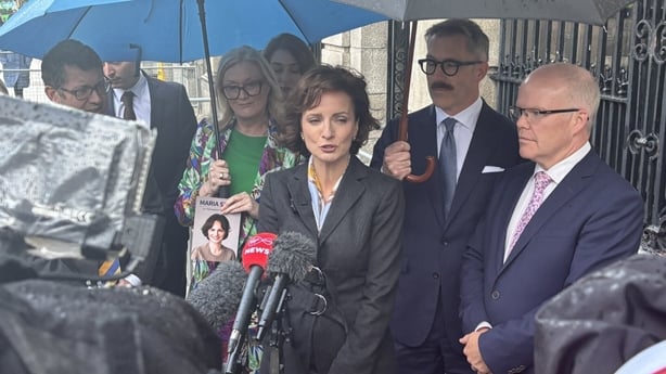 Maria steen is flanked by 5 supporters outside leinster house