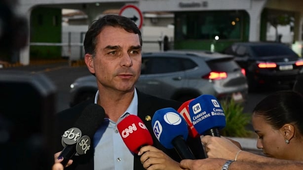 Senator Flavio Bolsonaro, son of former Brazilian President Jair Bolsonaro, speaks to the media outside his father's residence