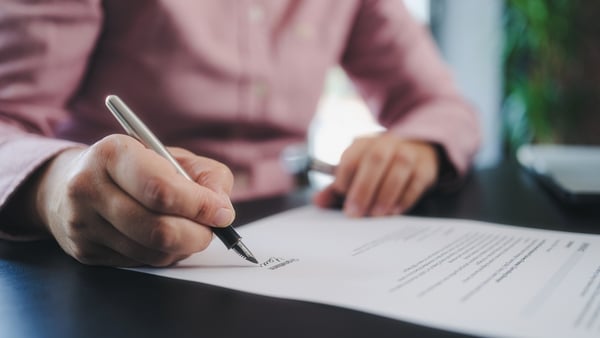 businesswoman signing an official document