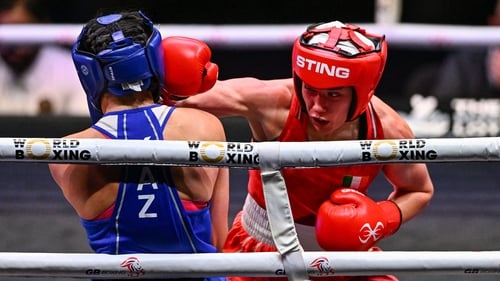 Gráinne Walsh (red) sees a right hook glance off the head of Aida Abikeyeva