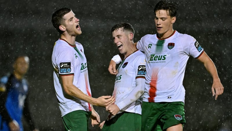 Darragh Crowley and Benny Couto flank Evan McLaughlin as the Cork City man celebrates his second goal of the night