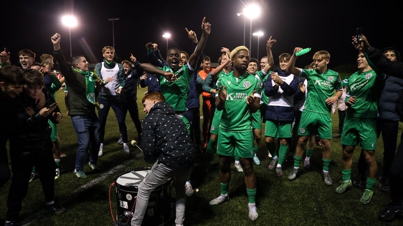 Daniel Okwute, sporting peroxide blond locks, celebrates with Kerry FC team-mates and fans