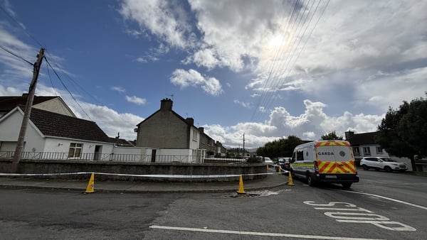Garda tape and a garda van outside a property in Tipperary town
