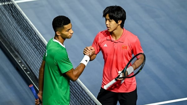 Michael Agwi of Ireland, left, and Yi Zhou of China PR shake hands after their singles match on day one of the Davis Cup World Group II match between Ireland and China PR at the Sport Ireland National Indoor Arena in Dublin.