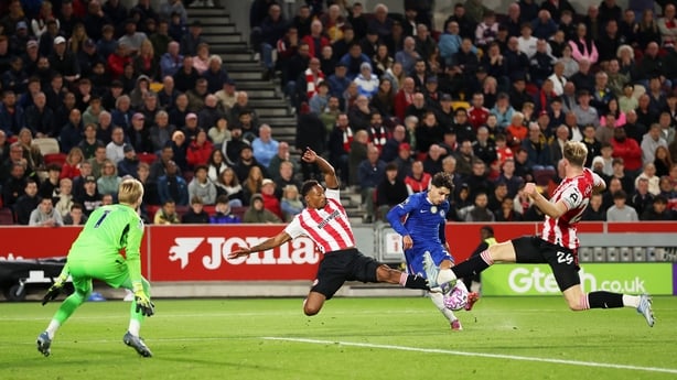 Pedro Neto of Chelsea is challenged by Ethan Pinnock and Nathan Collins of Brentford during the Premier League match between Brentford and Chelsea at Gtech Community Stadium on September 13, 2025 in Brentford, England.