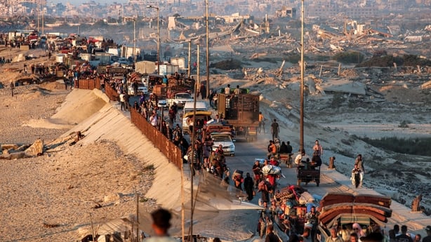 Displaced Palestinians evacuating southbound from Gaza City travel on foot and by vehicle 