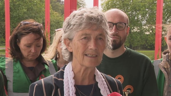 Catherine Connolly speaking to media in front of a group of canvassers in Cork