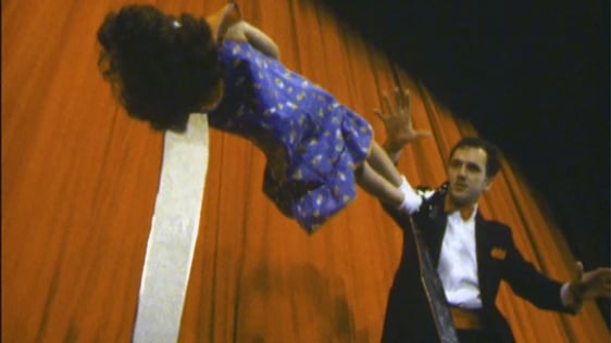Magician Pat O'Sullivan, known as The Great Silvano, performs an elevation act with his young assis…