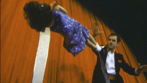 Magician The Great Silvano performs an elevation act with his young assistant Anita in 1985.