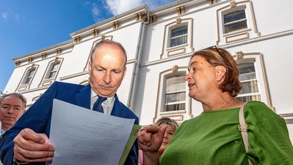 Antoinette Burke (right), mother of Katie Burke from Cobh, confronts Taoiseach Micheal Martin