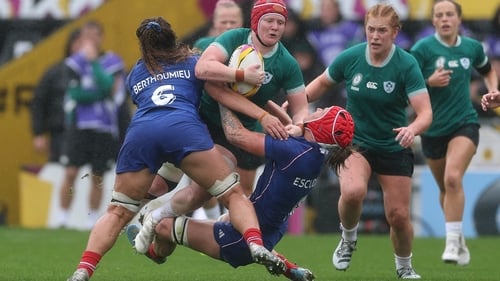 Ireland's Aoife Wafer is tackled by Axelle Berthoumieu (L) and Charlotte Escudero during the Women's Rugby World Cup quarter-final