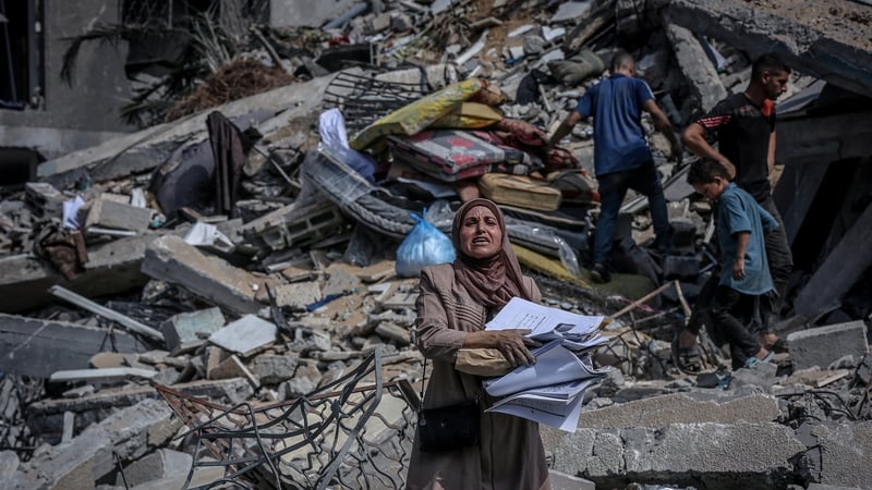 Palestinians search among rubble after an Israeli attack on the Rimal neighbourhood of Gaza City