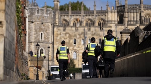 Police officers carry out security searches outside of Windsor Castle