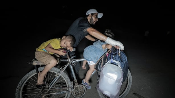Palestinians move toward central Gaza through Al-Rashid Street using vehicles, horse carts, and travelling on foot