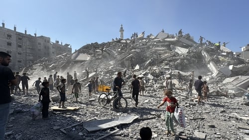 Palestinians inspect the scale of destruction after Israeli attacks on Gaza City