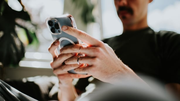Mans hand holding a mobile phone. 