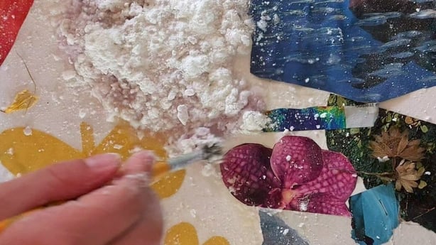 A close-up of a hand working on artwork