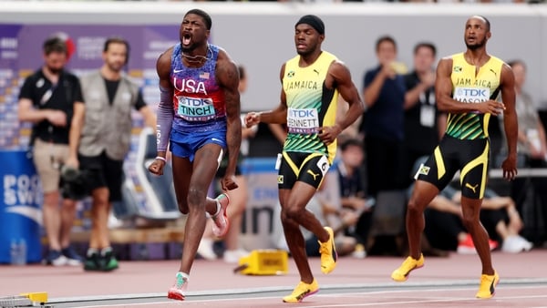 Cordell Tinch of Team United States (L) celebrates as he crosses the finish line to win the gold medal followed by silver medalist Orlando Bennett of Team Jamaica (C) and bronze medalist Tyler Mason of Team Jamaica (R) in the Men's 110 Metres Hurdles Fina