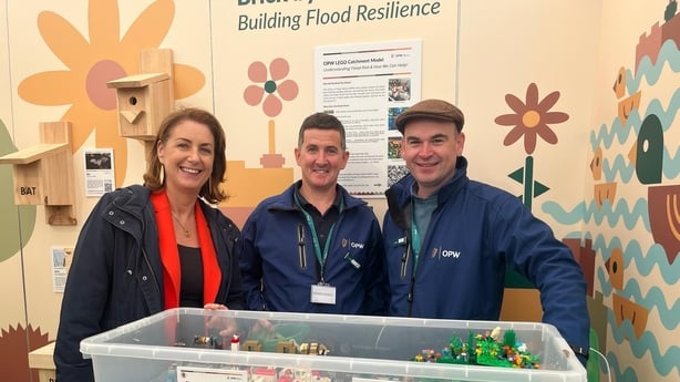 Katie Hannon talks with OPW engineers Barry Doherty (right) and Leo Donnellan (centre), who are using Lego to explain to children how flood defences work
