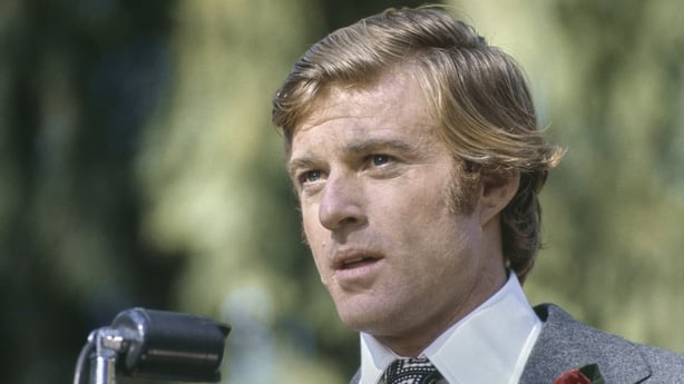 American actor Robert Redford wearing a grey blazer over a white shirt with a patterned tie, and a red flower in his buttonhole, in a scene from 'The Candidate', filmed in California, United States, 1972. The political comedy, directed by Michael Ritchie, starred Redford as Bill McKay. (Photo by Mic