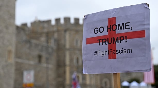 A demonstrator holds up an anti-Donald Trump sign near Windsor Castle