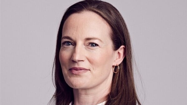Picture of a lady posing against a grey background