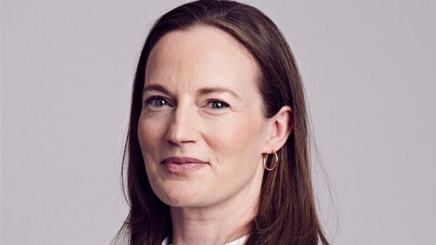 Picture of a lady posing against a grey background