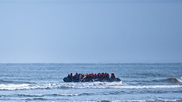 A refugee boat sets off to cross the English Channel in Wimereux, northern France