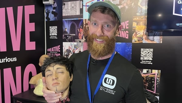 Ciarán Cooke with a prop of a head at the exhibition