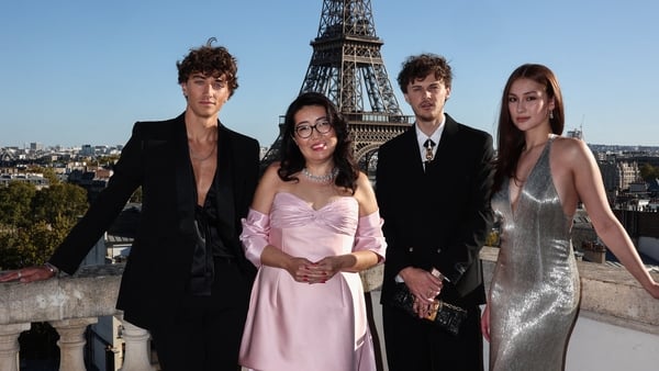 (L-R) Gavin Casalegno, Jenny Han, Christopher Briney, and Lola Tung pose during a photocall on the roof of the Shangri-La Hotel prior to a special screening of the final episode of The Summer I Turned Pretty, in Paris, on 17 September
